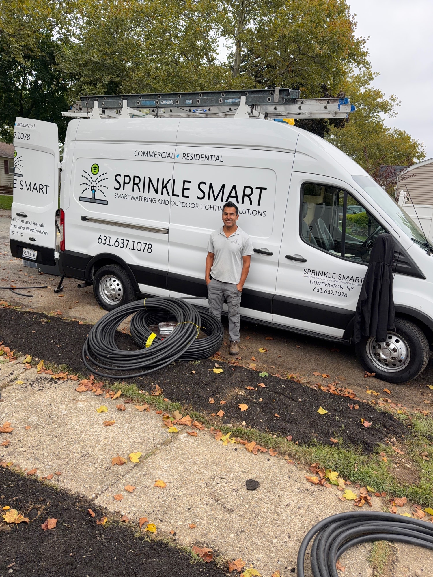 Julio Aguilar beside the Sprinkle Smart van and irrigation supplies